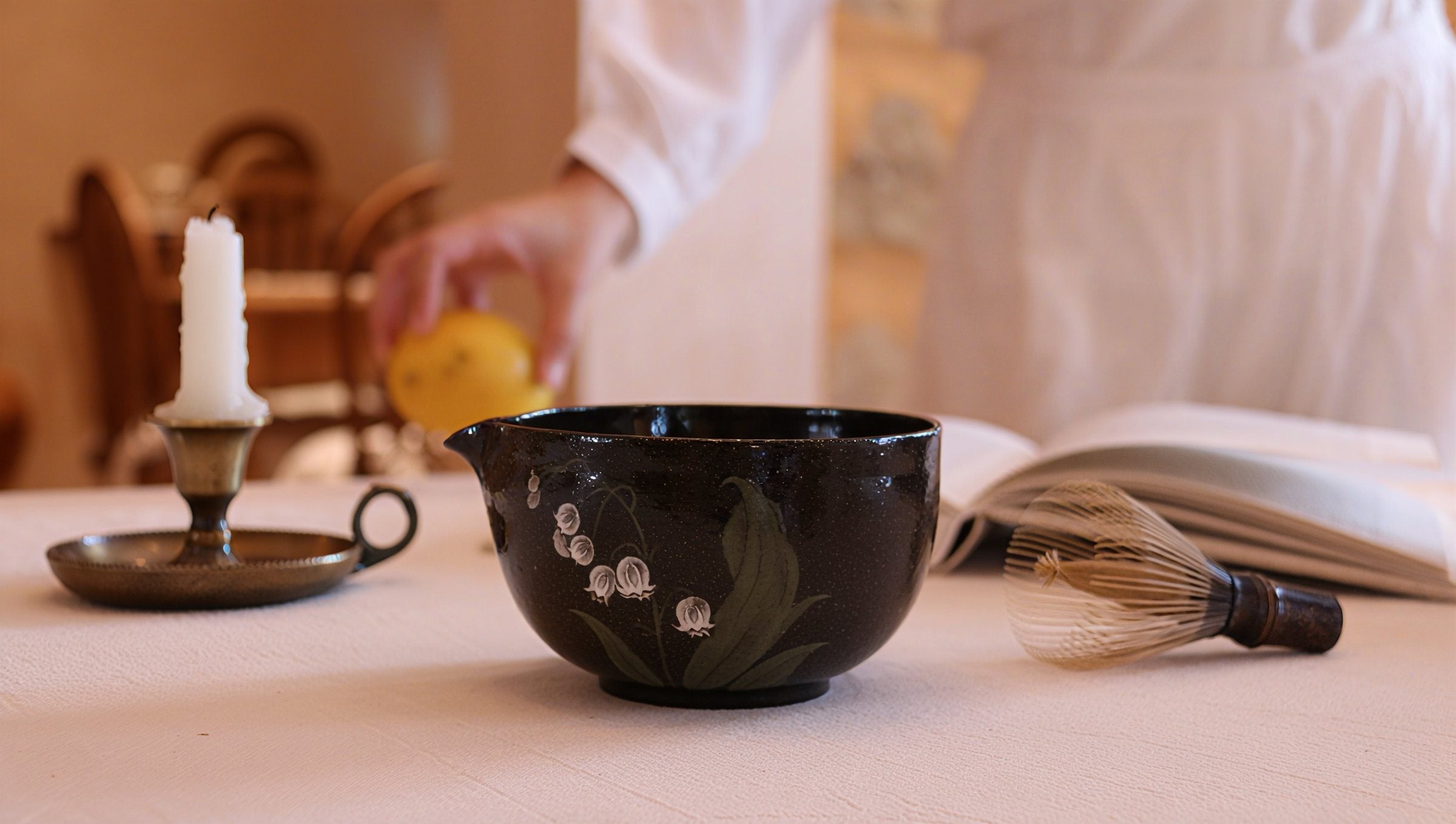 The Lily of the Valley matcha bowl in a tea setting